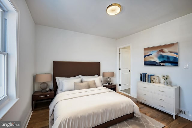 bedroom with dark wood-type flooring