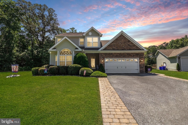 view of front of home featuring a garage and a lawn