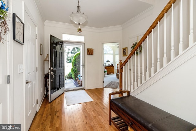 19045 Carey Ln, Georgetown, DE 19947 - entryway with light wood finished floors, stairs, and ornamental molding