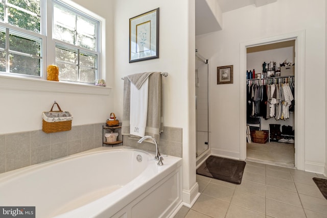 bathroom with tile patterned flooring and separate shower and tub