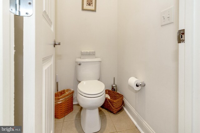 bathroom with toilet and tile patterned floors