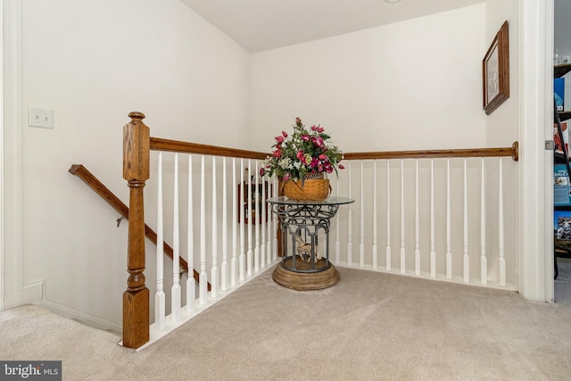 staircase with lofted ceiling and carpet