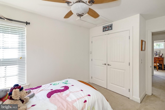 carpeted bedroom with a closet and ceiling fan