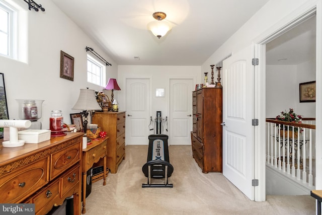 exercise room with light carpet