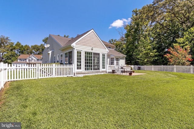 19045 Carey Ln, Georgetown, DE 19947 - back of property with a lawn, a fenced backyard, a patio, and roof with shingles