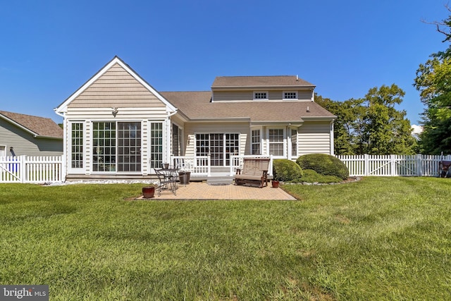 rear view of house featuring a lawn and a patio area