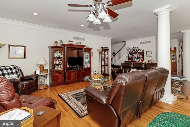 living room featuring light hardwood / wood-style floors, ornamental molding, ceiling fan, and ornate columns