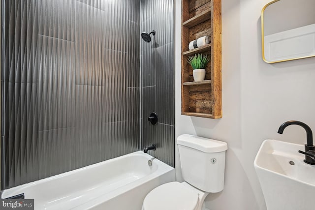 full bathroom featuring sink, toilet, and tiled shower / bath