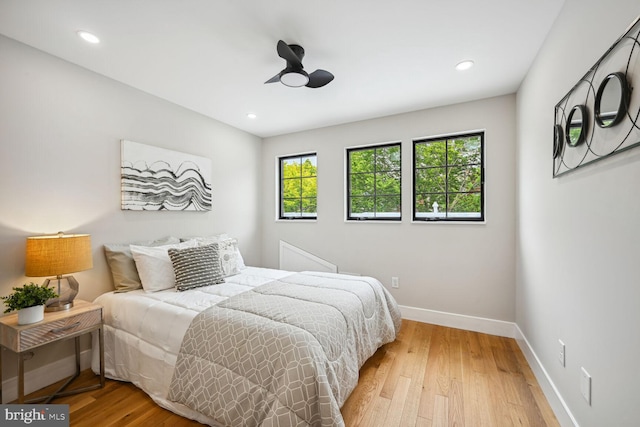 bedroom with light wood-type flooring and ceiling fan