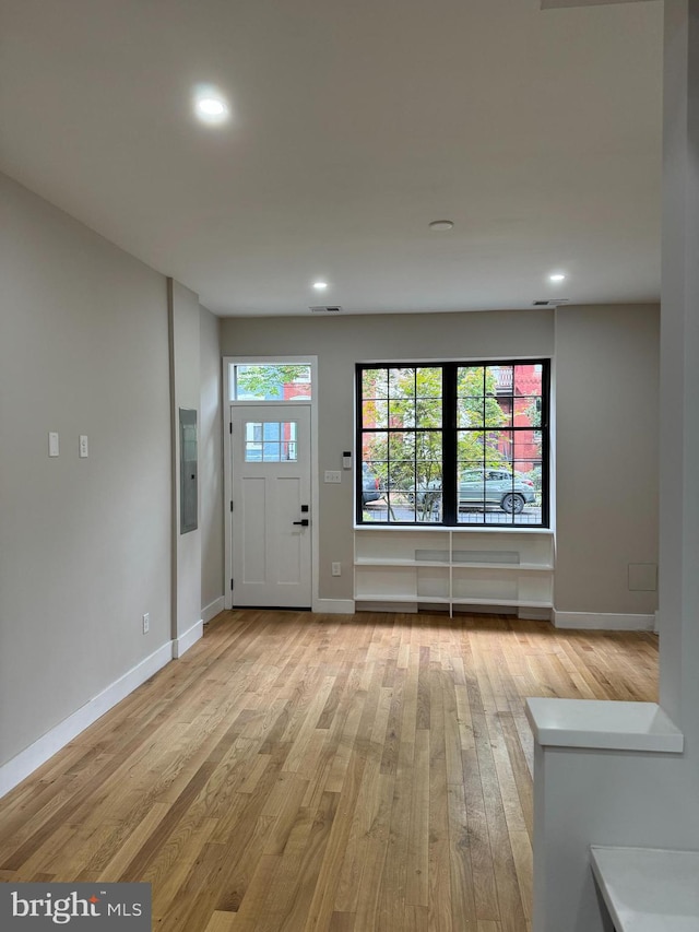 entrance foyer featuring electric panel and light hardwood / wood-style floors