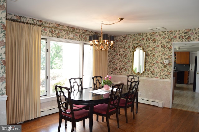 dining space featuring an inviting chandelier, dark hardwood / wood-style flooring, and a baseboard heating unit