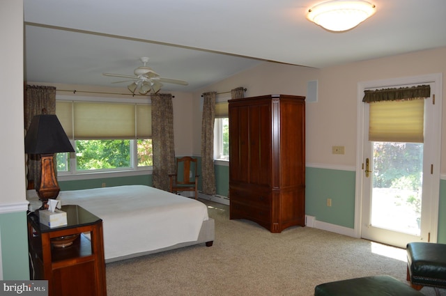 bedroom featuring ceiling fan, light colored carpet, access to exterior, and multiple windows