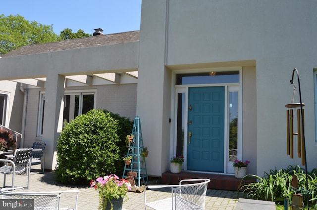 entrance to property with a patio