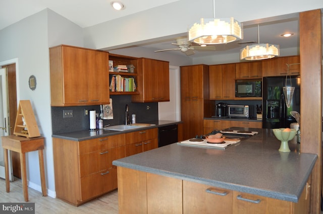 kitchen featuring backsplash, light wood-type flooring, black appliances, ceiling fan, and sink