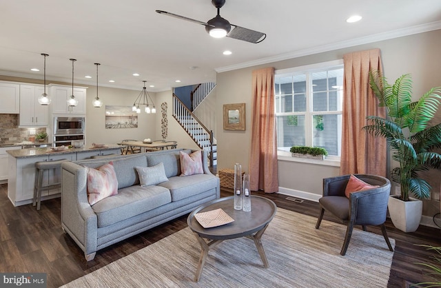 living room featuring crown molding, ceiling fan, and dark wood-type flooring