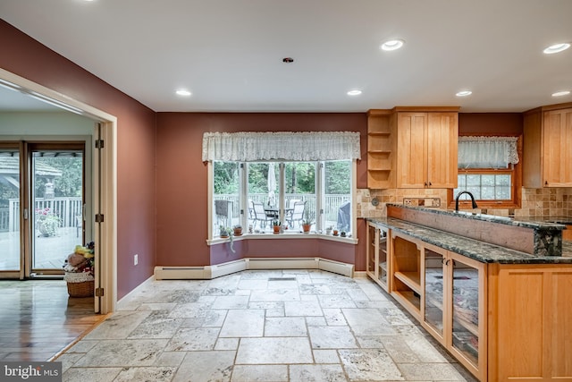 kitchen featuring dark stone counters and backsplash