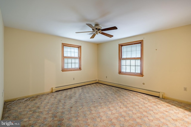 carpeted spare room with ceiling fan and baseboard heating