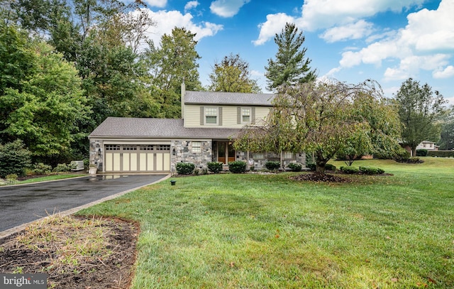 view of front of property featuring a garage and a front yard