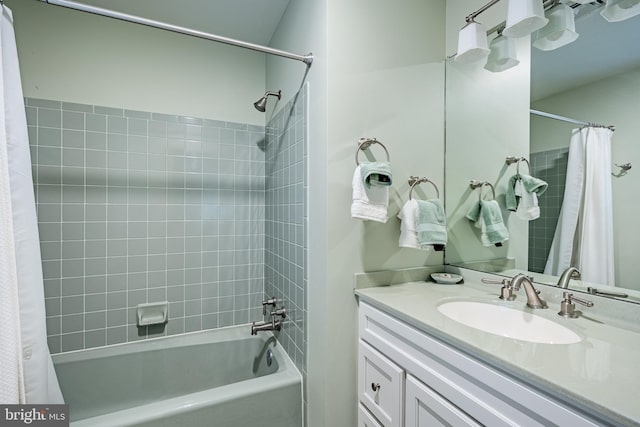 bathroom featuring shower / bath combo and vanity