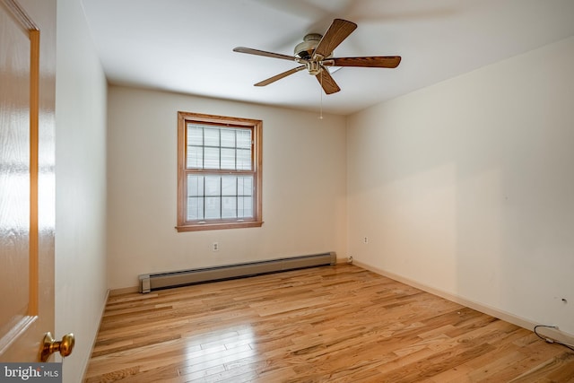 empty room featuring ceiling fan, baseboard heating, and light hardwood / wood-style flooring