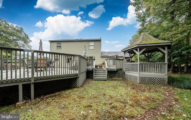 back of house featuring a wooden deck and a gazebo