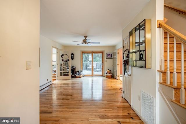 interior space featuring light hardwood / wood-style floors and baseboard heating