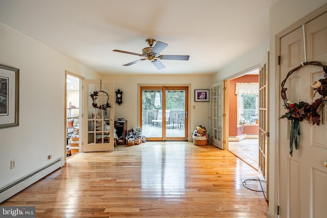 interior space with french doors, light wood-type flooring, a baseboard heating unit, and ceiling fan