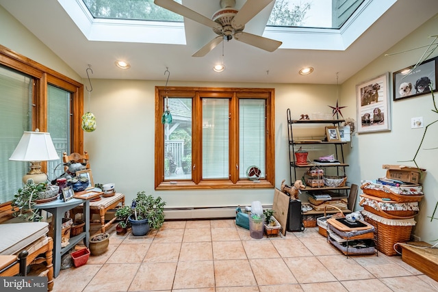 interior space with ceiling fan, light tile patterned floors, baseboard heating, and lofted ceiling with skylight