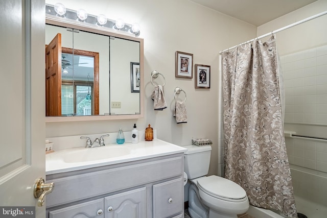 full bathroom featuring shower / tub combo, vanity, and toilet