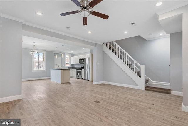 unfurnished living room with light wood-type flooring, crown molding, and ceiling fan