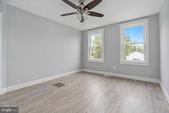 spare room with ceiling fan and light wood-type flooring