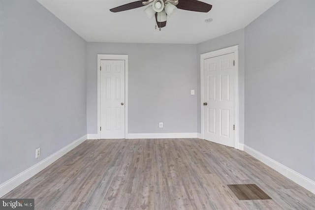 spare room featuring light hardwood / wood-style floors and ceiling fan