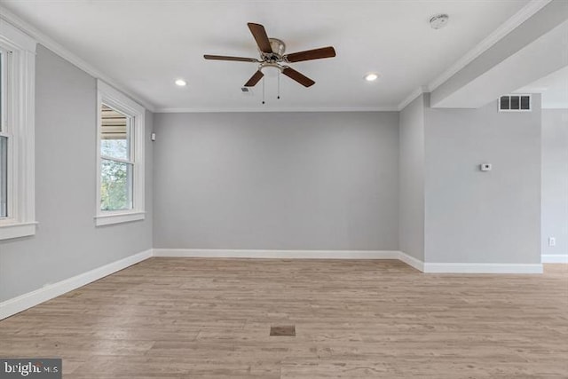 unfurnished room with ornamental molding, light wood-type flooring, and ceiling fan