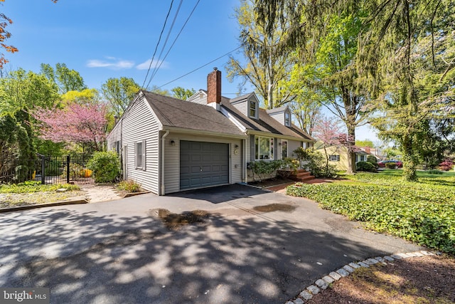 new england style home featuring a garage