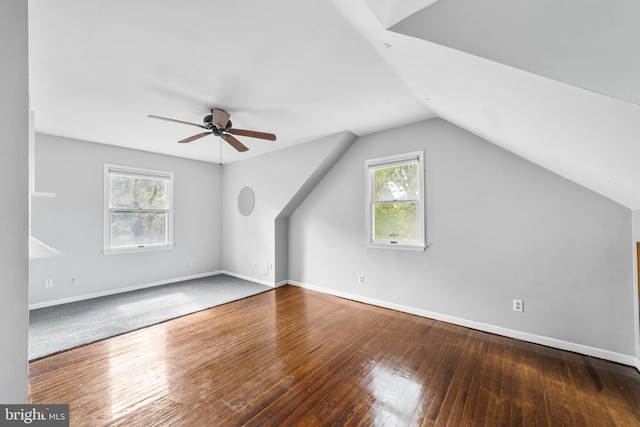 additional living space with a wealth of natural light, lofted ceiling, ceiling fan, and hardwood / wood-style flooring