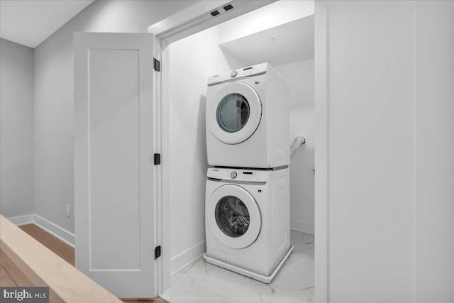 laundry room with stacked washing maching and dryer