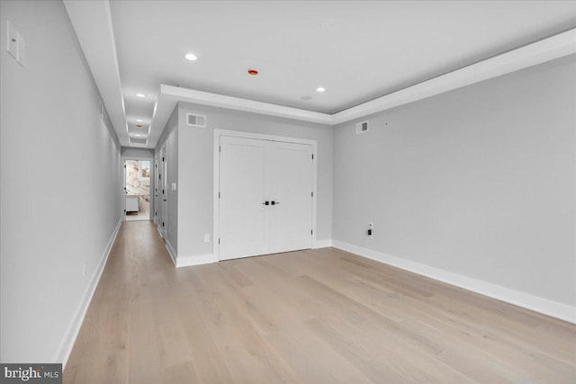 unfurnished bedroom with light hardwood / wood-style floors and a closet