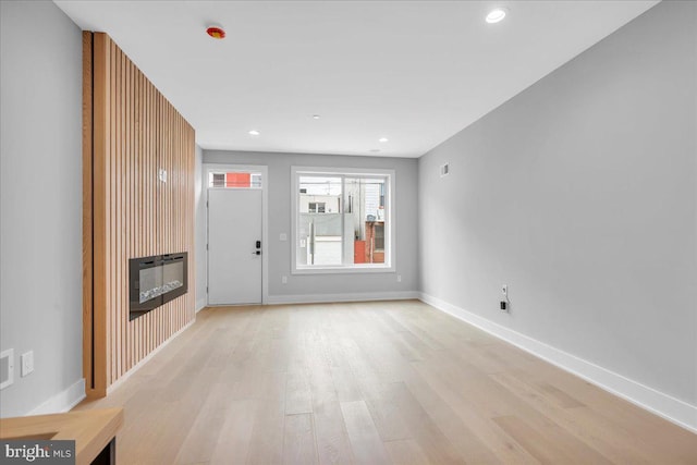 unfurnished living room featuring light hardwood / wood-style floors