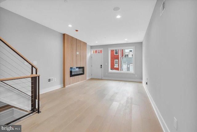 unfurnished living room featuring light hardwood / wood-style flooring