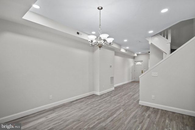 interior space featuring an inviting chandelier and hardwood / wood-style flooring