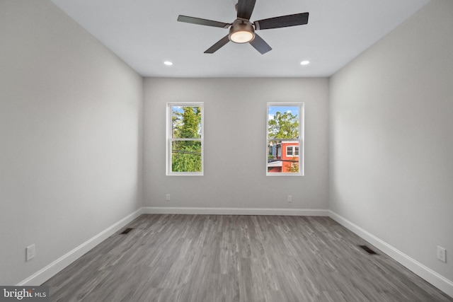 empty room with wood-type flooring and ceiling fan