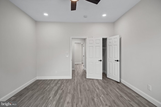 unfurnished bedroom featuring ceiling fan and hardwood / wood-style floors