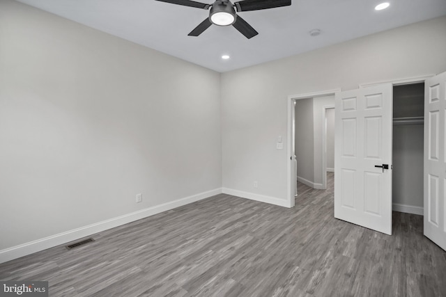 unfurnished bedroom featuring a closet, ceiling fan, and hardwood / wood-style flooring