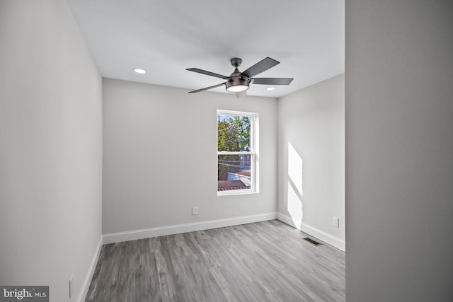 unfurnished room with ceiling fan and light wood-type flooring