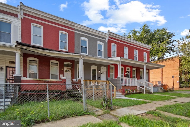 townhome / multi-family property with a porch