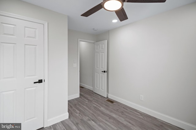 unfurnished bedroom featuring ceiling fan and light hardwood / wood-style flooring