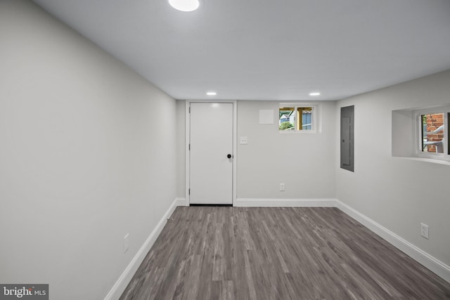 basement with electric panel and hardwood / wood-style floors