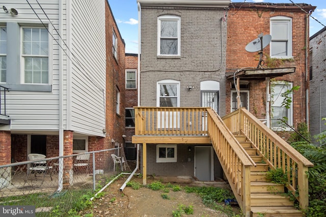 rear view of house featuring a wooden deck