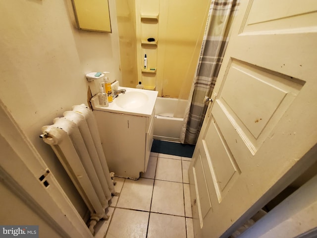 bathroom with radiator heating unit, shower / bath combo with shower curtain, tile patterned flooring, and vanity