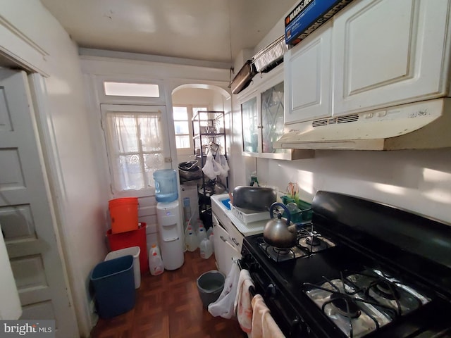 kitchen with white cabinetry, dark parquet floors, and black range with gas stovetop